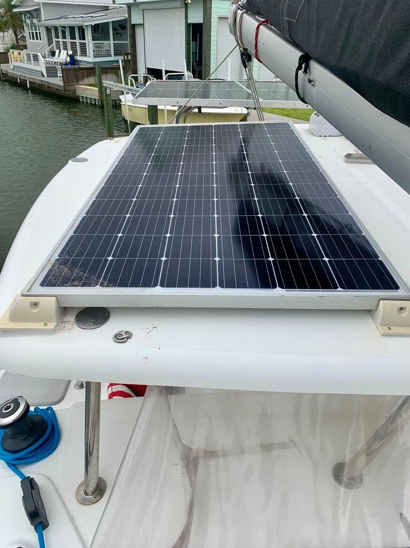 Slide: The Image of Solar panel on 2019 Lagoon 380 S2 4/2 catamaran docked by waterfront homes. - 5
