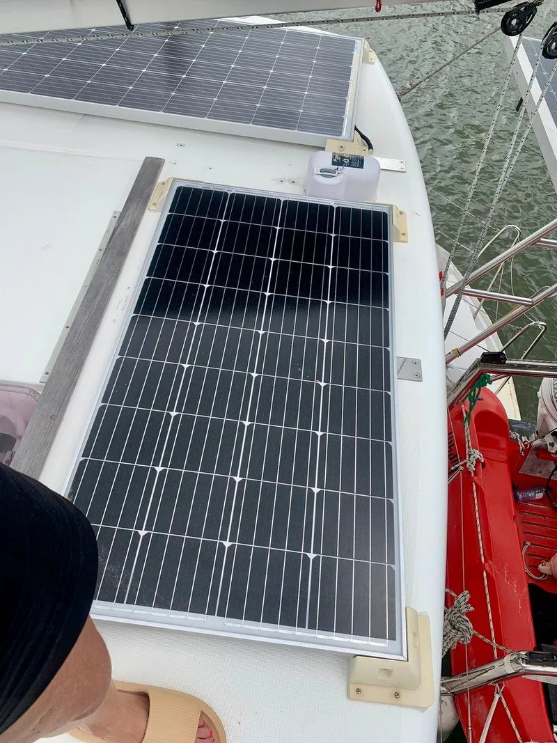 Slide: The Image of Solar panels on 2019 Lagoon 380 S2 4/2 catamaran deck, near water. - 7