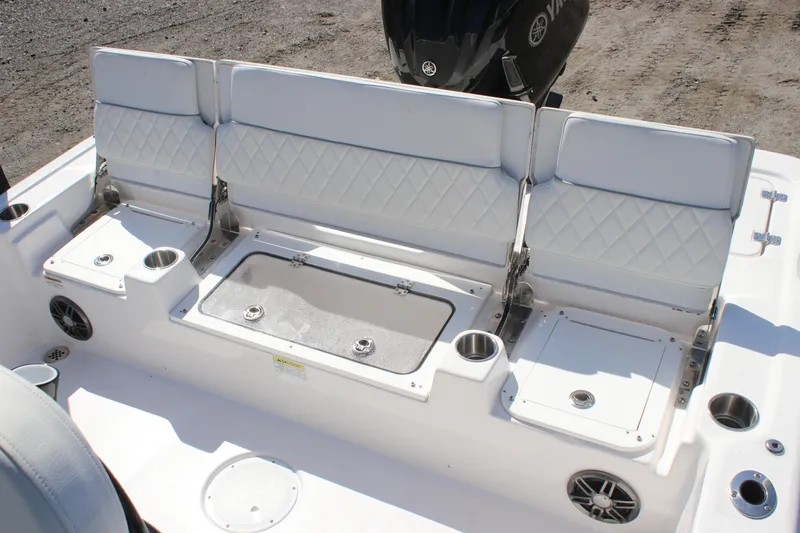 Slide: The Image of 2025 Sea Fox 251 Bay Fox boat seating area with storage and cup holders. - 10