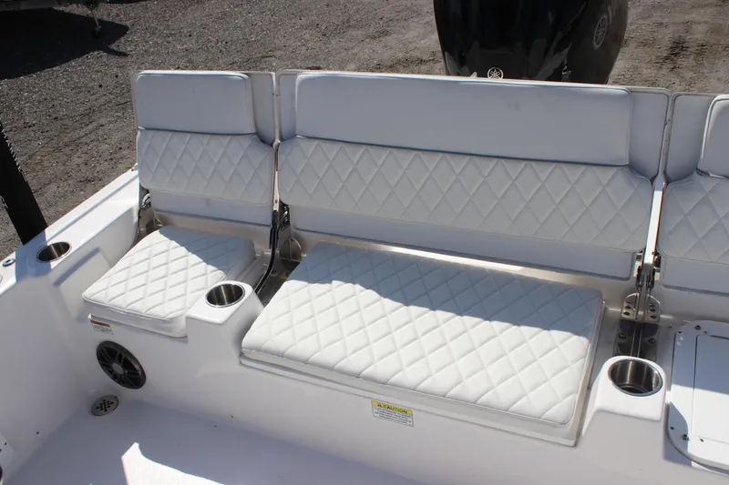 Slide: The Image of 2025 Sea Fox 251 Bay Fox boat seating with diamond-stitched upholstery and cup holders. - 11