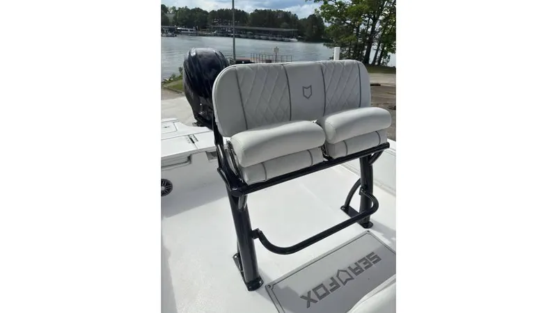 Slide: The Image of 2025 Sea Fox 251 Bay Fox boat seating with lake view in background. - 17