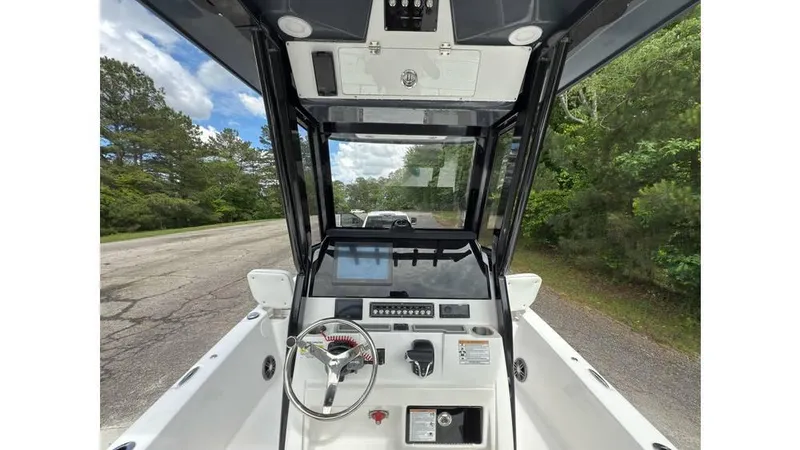 Slide: The Image of 2025 Sea Fox 251 Bay Fox boat console with steering wheel and controls. - 18