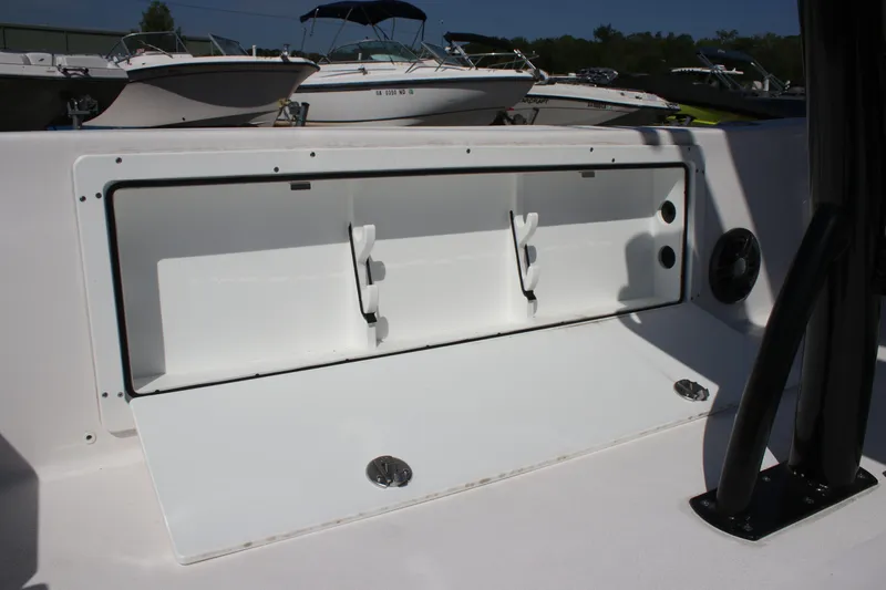 Slide: The Image of 2025 Sea Fox 251 Bay Fox boat storage compartment open, showcasing interior space. - 23