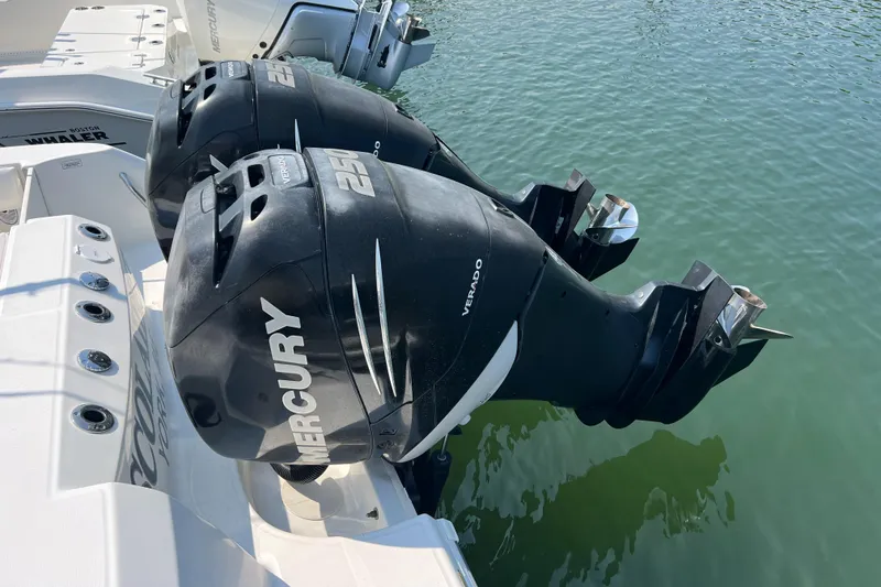 Slide: The Image of 2012 Boston Whaler 280 Outrage with twin Mercury outboard engines on water. - 2