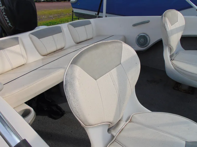 Slide: The Image of 2013 Bayliner 160BR boat interior with white seating and speaker. - 10