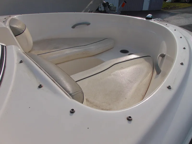 Slide: The Image of 2013 Bayliner 160BR boat interior with white seating and sleek design. - 11
