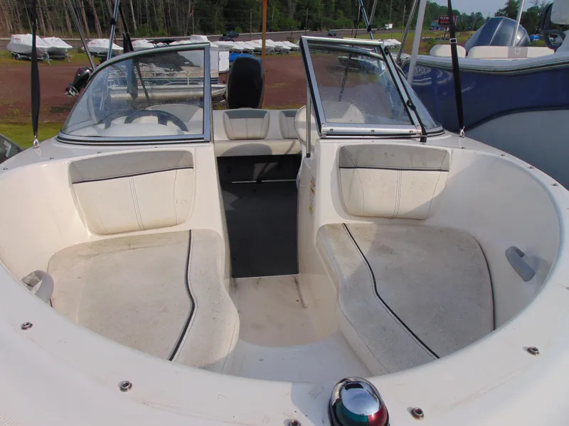 Slide: The Image of 2013 Bayliner 160BR boat interior with seating and windshield. - 5