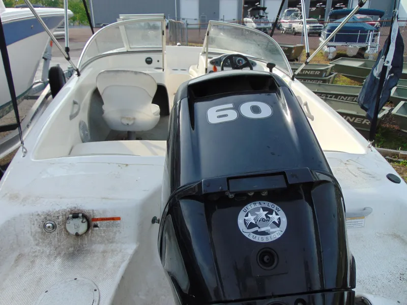 Slide: The Image of 2013 Bayliner 160BR boat interior with 60 HP outboard motor. - 8