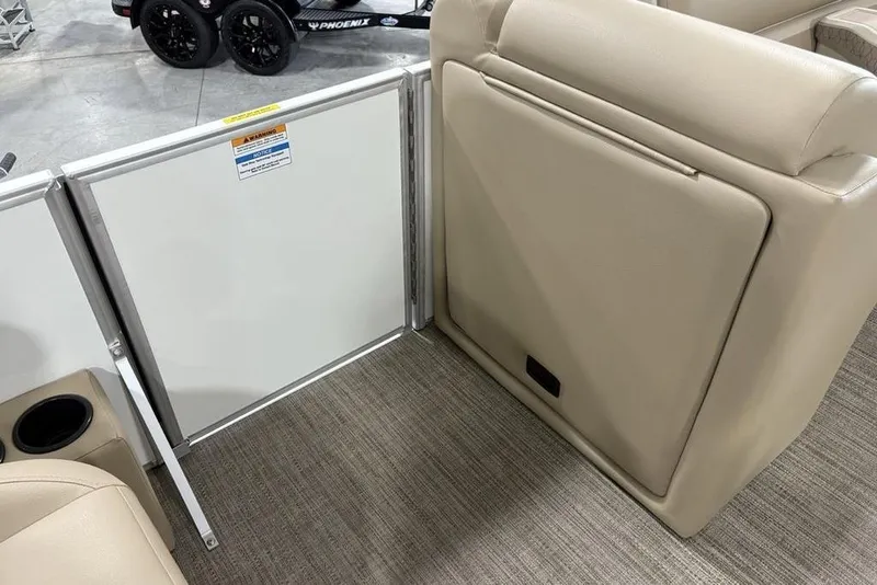 Slide: The Image of 2025 Godfrey Xperience 2286 SBX Sport Tube interior with beige seating and storage compartment. - 11