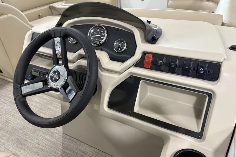 Slide: The Image of Steering console of 2025 Godfrey Xperience 2286 SBX Sport Tube boat, featuring gauges and controls. - 17