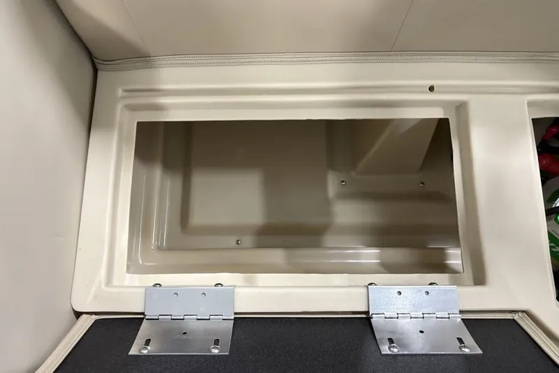 Slide: The Image of Open storage compartment in 2025 Godfrey Xperience 2286 SBX Sport Tube boat. - 21