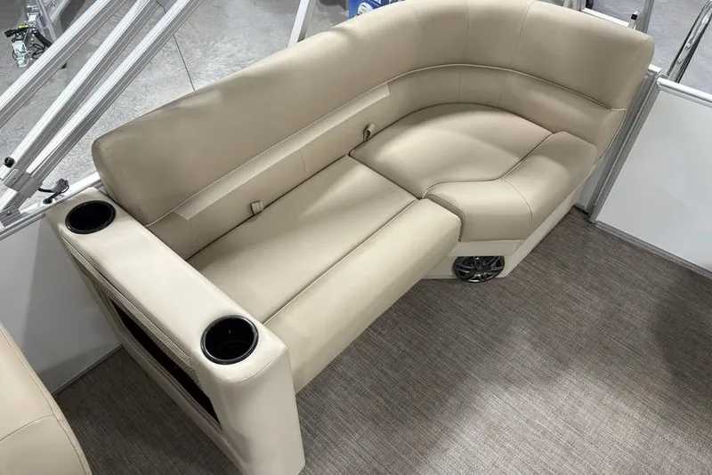 Slide: The Image of Luxurious seating on 2025 Godfrey Xperience 2286 SBX Sport Tube boat, featuring beige upholstery and cup holders. - 23