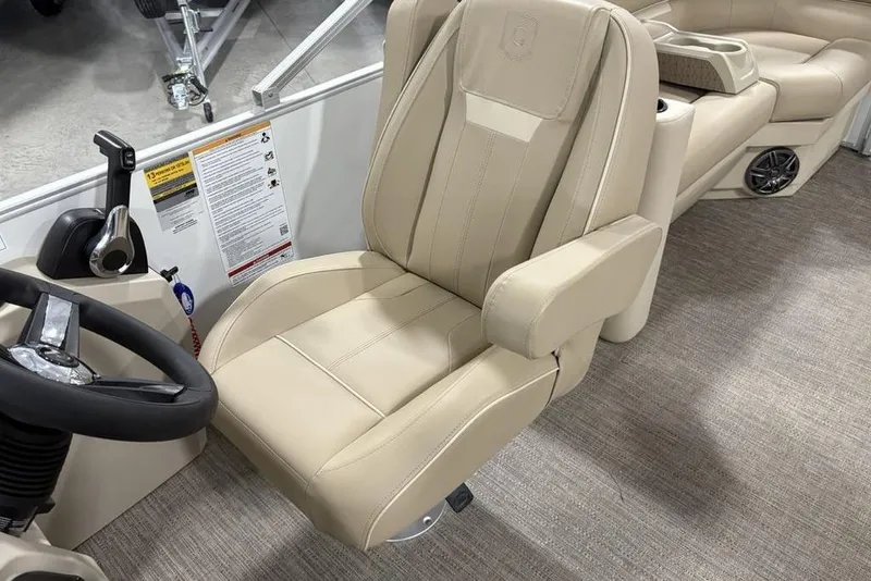 Slide: The Image of 2025 Godfrey Xperience 2286 SBX Sport Tube interior with beige captain's chair and steering wheel. - 24