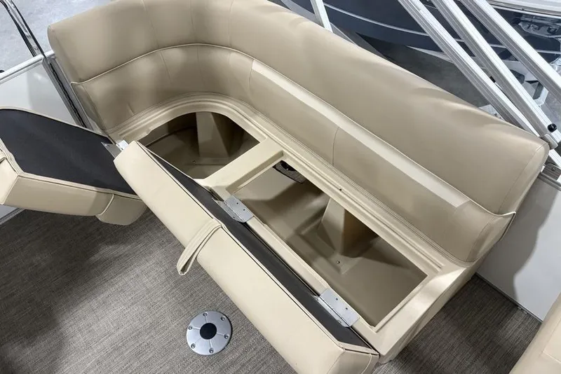 Slide: The Image of 2025 Godfrey Xperience 2286 SBX Sport Tube boat with open storage compartment and beige seating. - 26