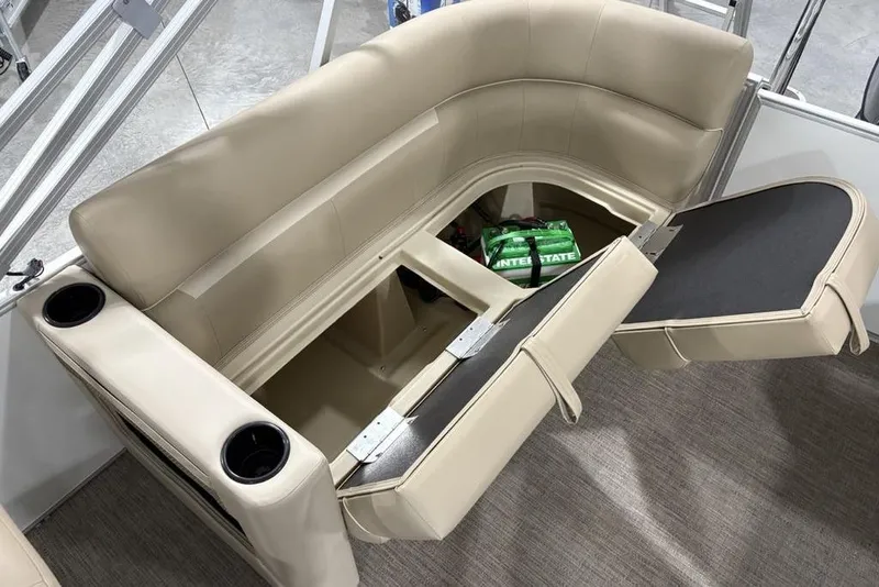 Slide: The Image of 2025 Godfrey Xperience 2286 SBX Sport Tube boat with open storage compartment and beige seating. - 27