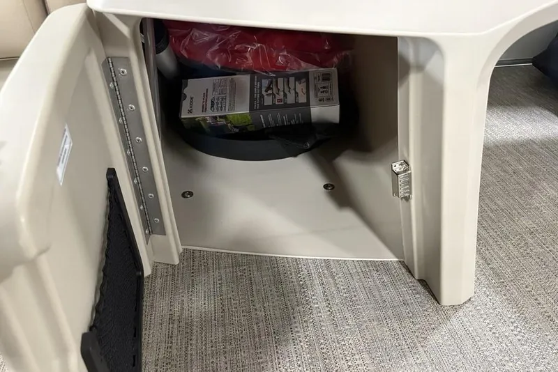 Slide: The Image of Open storage compartment in 2025 Godfrey Xperience 2286 SBX Sport Tube boat. - 6