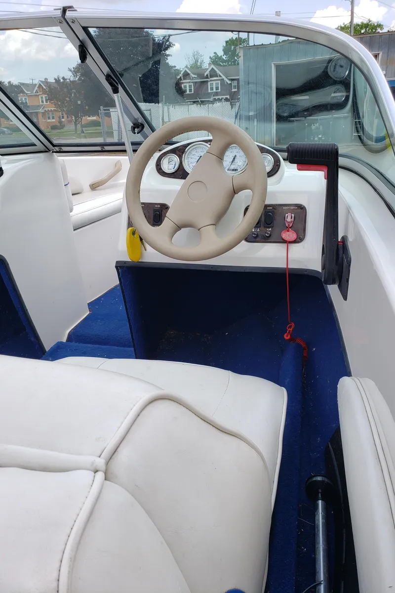 Slide: The Image of Interior of a 1998 Sunbird 150 boat showing steering wheel and dashboard controls. - 5