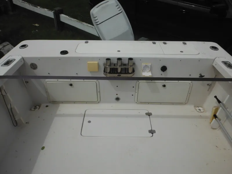 Slide: The Image of 1997 Pro-Line 231 WA boat deck with storage compartments and rod holders. - 12