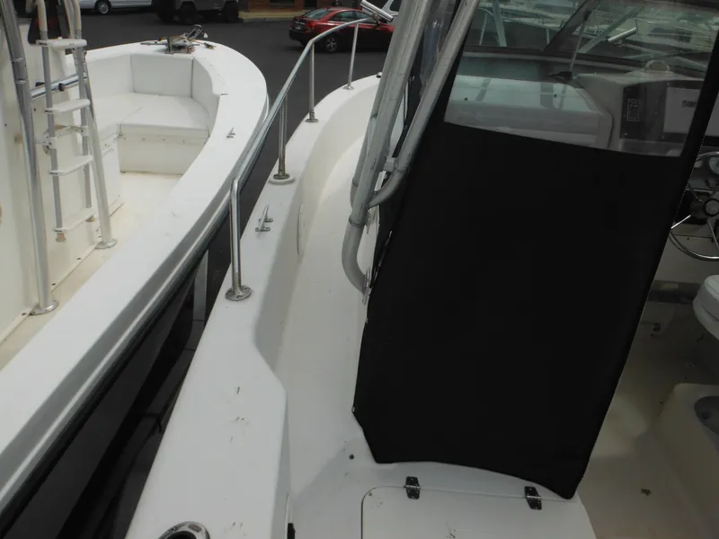 Slide: The Image of 1997 Pro-Line 231 WA boat deck with railing and cabin view. - 14