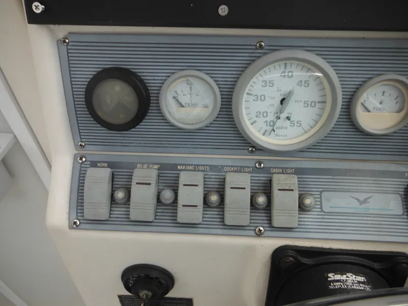 Slide: The Image of Control panel of a 1997 Pro-Line 231 WA boat with gauges and switches. - 27