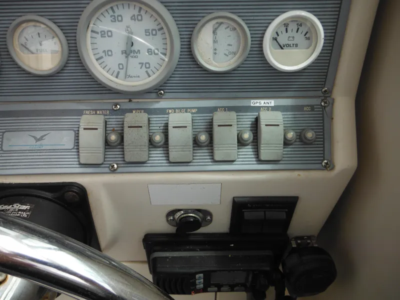 Slide: The Image of Dashboard of a 1997 Pro-Line 231 WA boat with gauges and switches. - 28