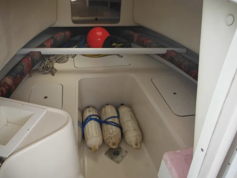 Slide: The Image of 1997 Pro-Line 231 WA boat interior with storage and safety equipment. - 30