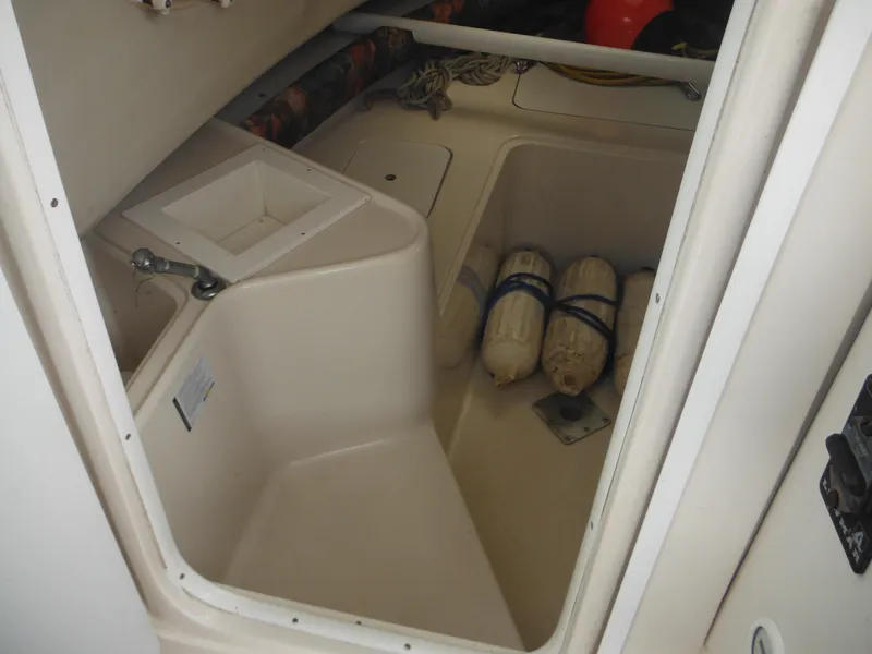 Slide: The Image of Interior of a 1997 Pro-Line 231 WA boat showing storage area with fenders. - 31