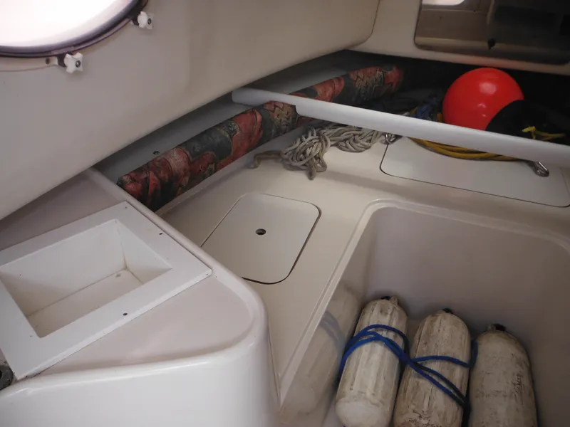 Slide: The Image of 1997 Pro-Line 231 WA boat interior with storage, ropes, and fenders. - 33