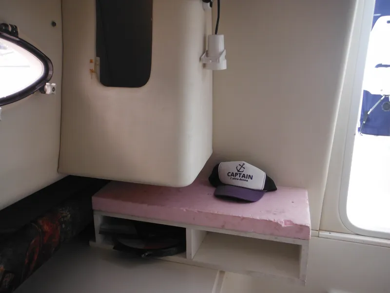 Slide: The Image of Interior of 1997 Pro-Line 231 WA boat with captain's hat on shelf. - 38
