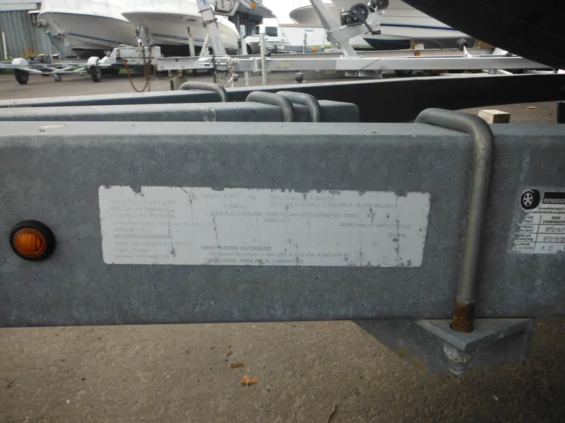 Slide: The Image of Trailer frame with label, Pro-Line 231 WA boat, 1997 model, in a boatyard setting. - 4