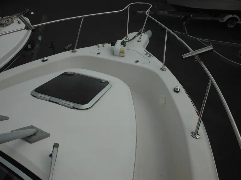 Slide: The Image of 1997 Pro-Line 231 WA boat deck with railing and hatch. - 42