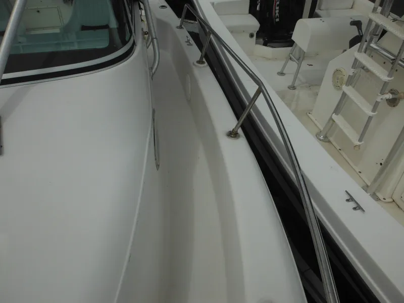 Slide: The Image of 1997 Pro-Line 231 WA boat deck with stainless steel railings and seating area. - 45