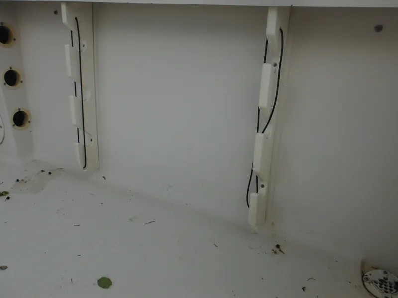 Slide: The Image of Interior view of a 1997 Pro-Line 231 WA boat, showing wiring and storage compartments. - 48