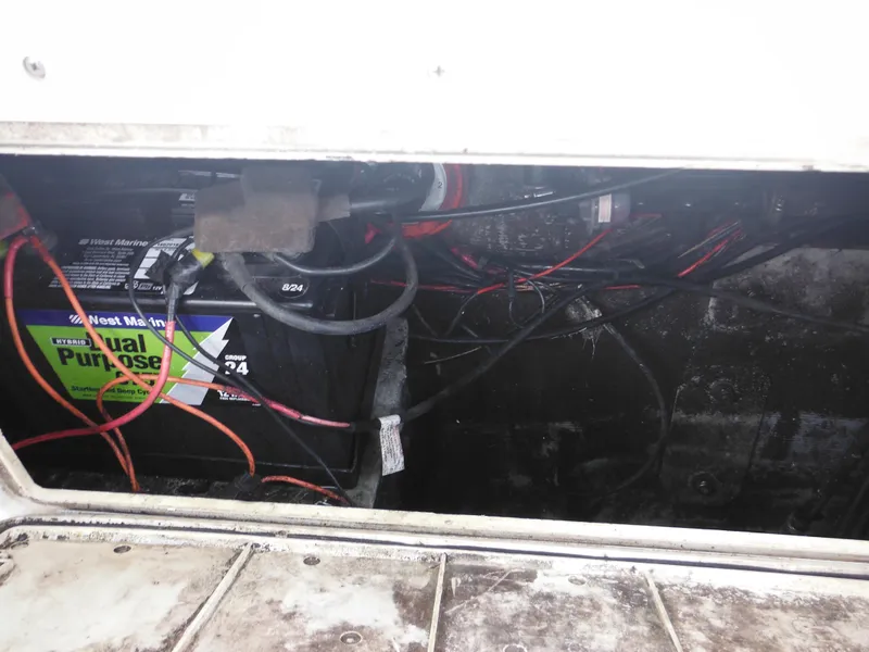 Slide: The Image of Battery compartment of a 1997 Pro-Line 231 WA boat with visible wiring. - 49