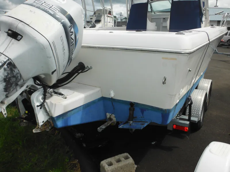 Slide: The Image of 1997 Pro-Line 231 WA boat on trailer with outboard motor, parked outdoors. - 7