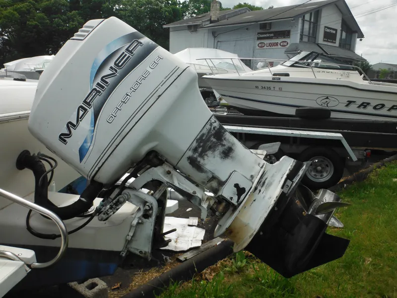 Slide: The Image of 1997 Pro-Line 231 WA boat with Mariner outboard motor in a marina setting. - 9