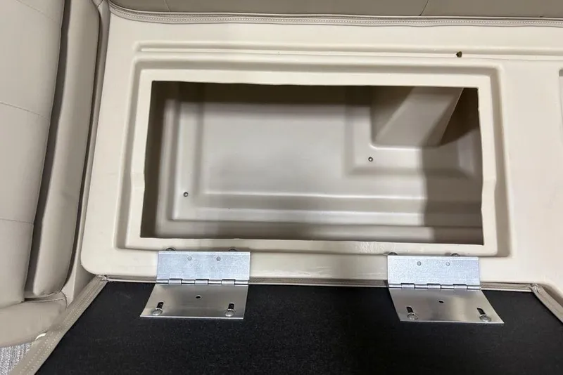 Slide: The Image of Storage compartment in 2025 Godfrey Xperience 2286 SBX boat, featuring durable hinges and beige interior. - 11