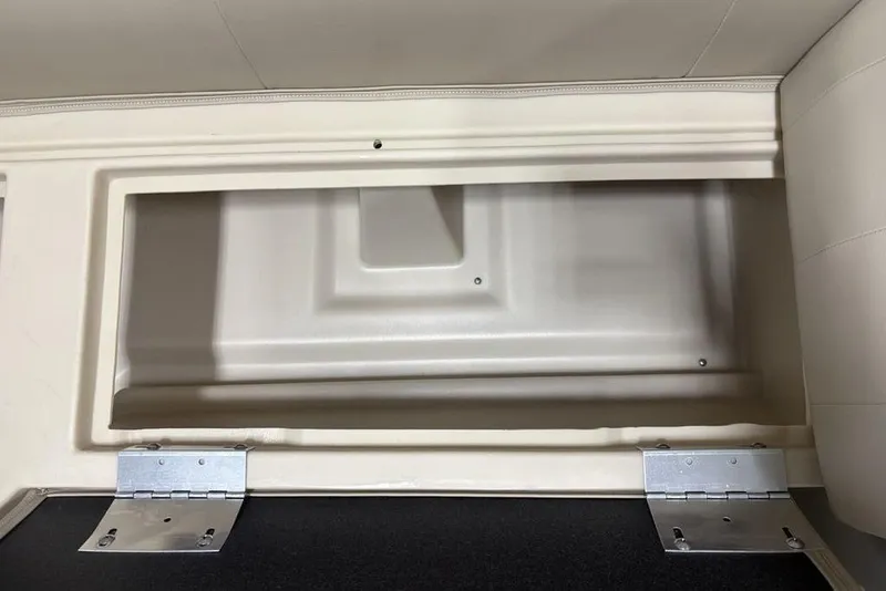 Slide: The Image of Storage compartment of 2025 Godfrey Xperience 2286 SBX boat with open lid and hinges. - 17