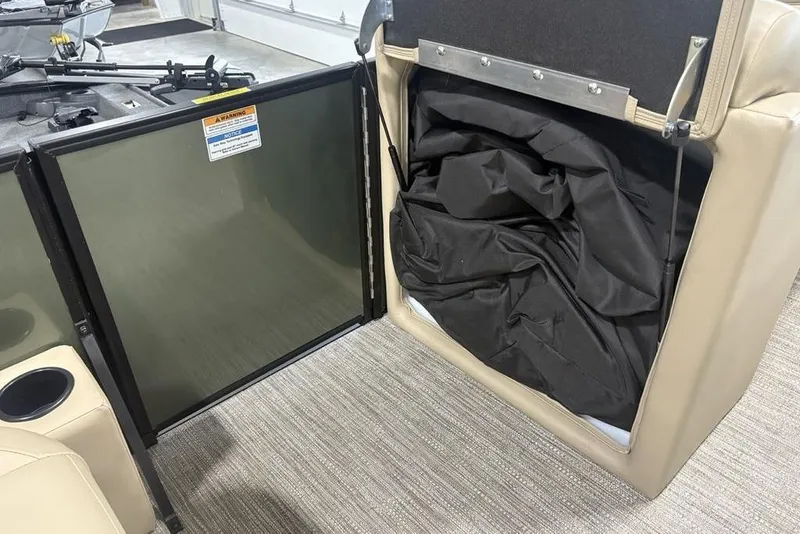 Slide: The Image of 2025 Godfrey Xperience 2286 SBX boat interior storage compartment with black fabric. - 23