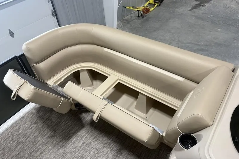 Slide: The Image of 2025 Godfrey Xperience 2286 SBX boat seating with storage, beige upholstery, and cup holder. - 25