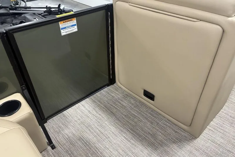 Slide: The Image of Interior of 2025 Godfrey Xperience 2286 SBX boat, featuring beige seating and safety gate. - 28