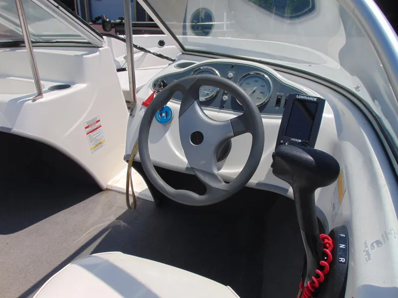 Slide: The Image of 2010 Bayliner 160 Bowrider cockpit with steering wheel and control panel. - 10