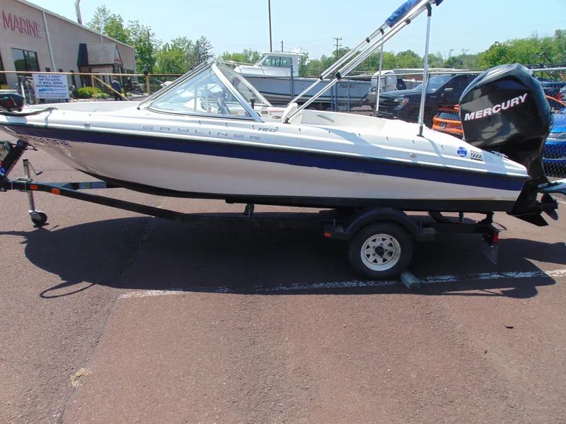 Slide: The Image of 2010 Bayliner 160 Bowrider boat on trailer with Mercury outboard motor. - 4