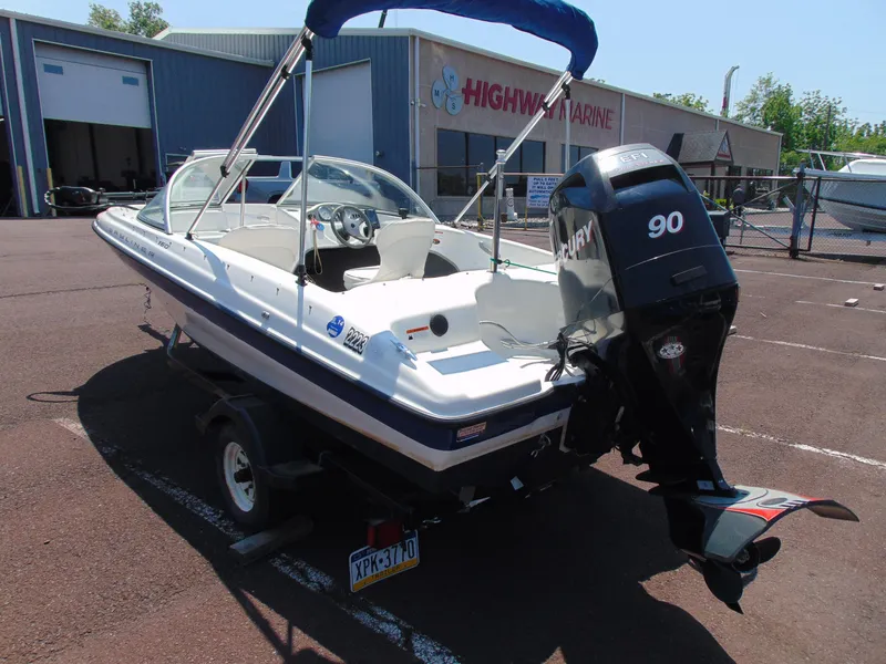 Slide: The Image of 2010 Bayliner 160 Bowrider with Mercury 90 engine in a marina parking lot. - 5
