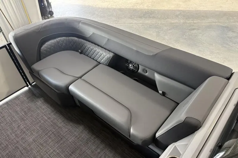 Slide: The Image of 2025 Godfrey Sweetwater 2286 SFL boat interior with luxurious gray seating and speaker system. - 11