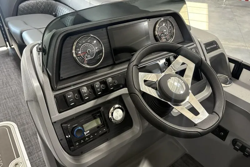 Slide: The Image of 2025 Godfrey Sweetwater 2286 SFL boat dashboard with steering wheel and control panel. - 17