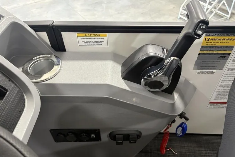 Slide: The Image of Control panel of 2025 Godfrey Sweetwater 2286 SFL boat with throttle and cup holder. - 23