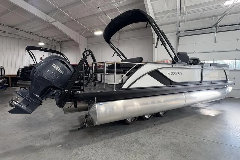Slide: The Image of 2025 Godfrey Sweetwater 2286 SFL pontoon boat with Yamaha engine in a showroom. - 4