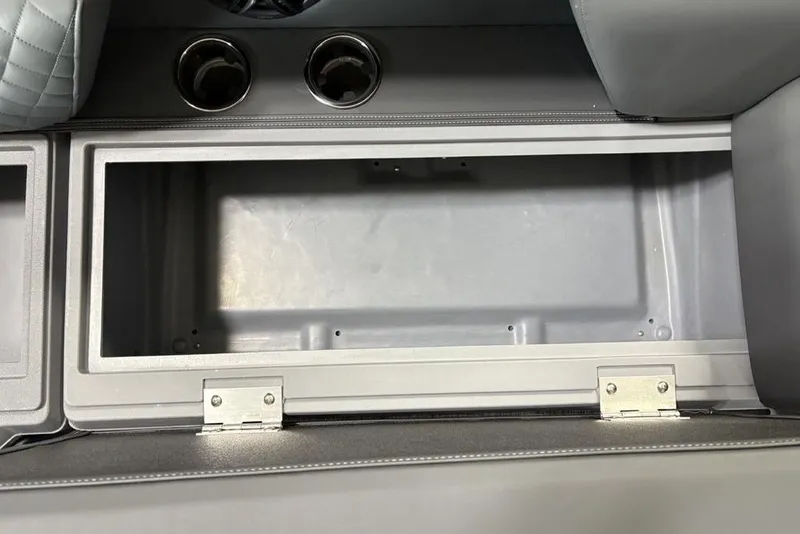 Slide: The Image of Storage compartment and cup holders in 2025 Godfrey Sweetwater 2286 SFL boat interior. - 5