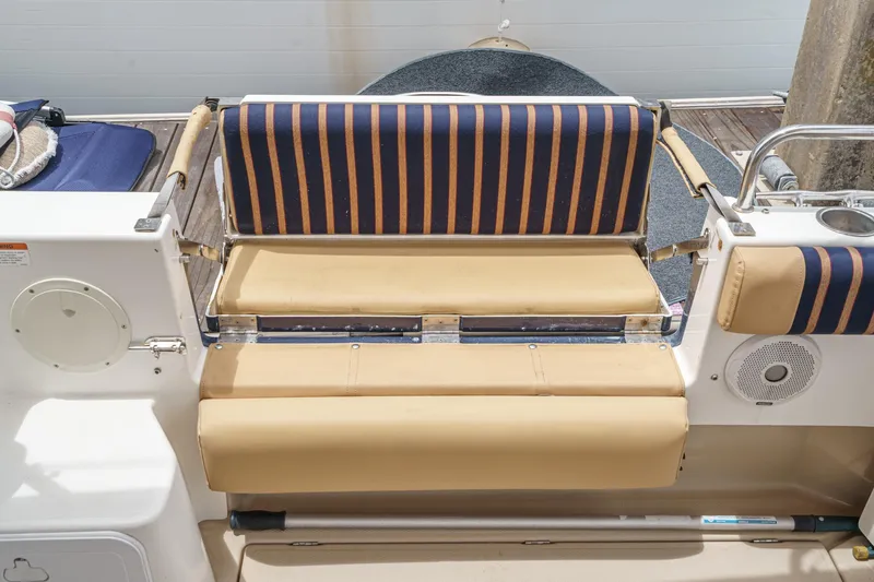 Slide: The Image of 2014 Cutwater C-30 SC LE boat seating with striped cushions and beige upholstery. - 13